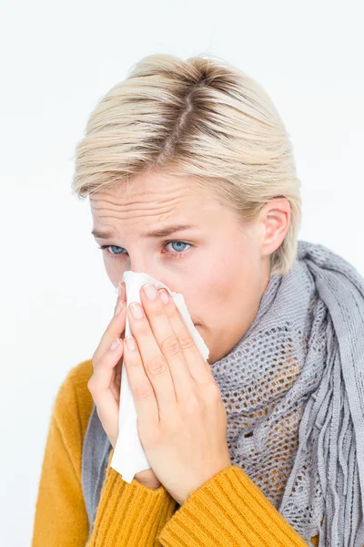 Woman blowing her nose Royalty Free Stock Images