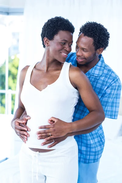 Pregnant wife looking at husband — Stock Photo, Image