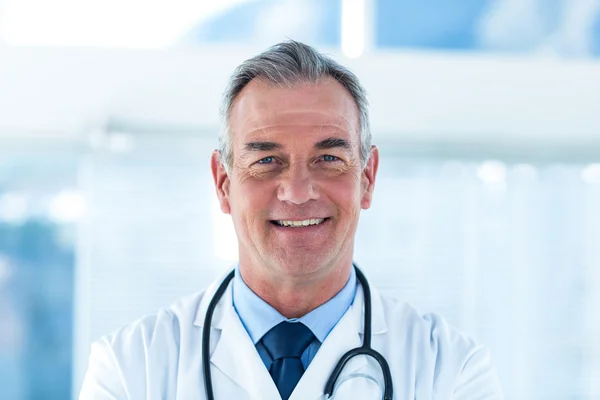 Smiling male doctor standing at clinic Royalty Free Stock Photos