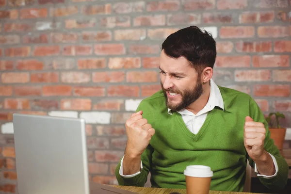 Excited businessman clenching fist in office — Stock Photo, Image