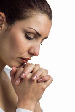 Close-up of woman praying with joining hands and eyes closed  clipart