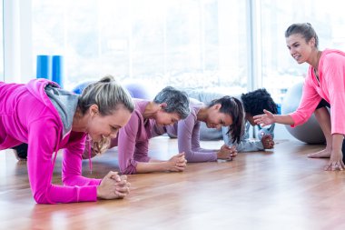 Group of women exercising on floor  clipart