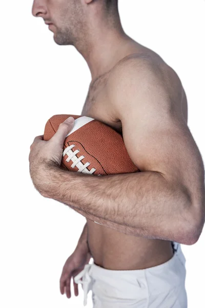 Vista lateral do jogador de rugby sem camisa segurando bola — Fotografia de Stock