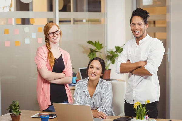 Portrait of happy business people with arms crossed in office — Stock Photo, Image