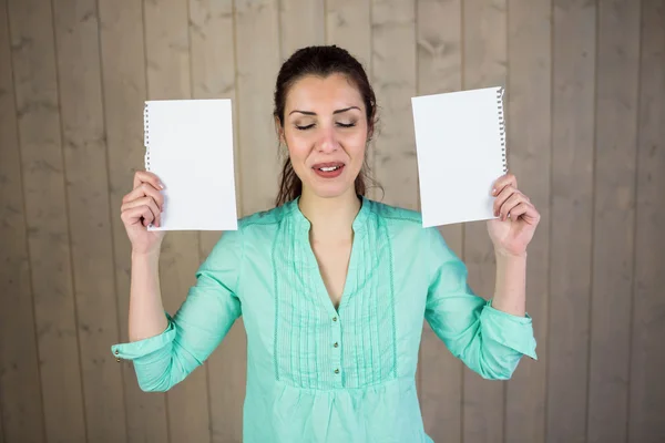 Smiling woman with eyes closed while holding papers — Stock Photo, Image