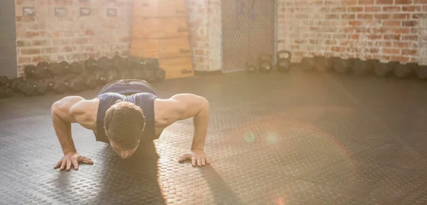 Handsome man doing wide arm push ups — Stock Photo, Image