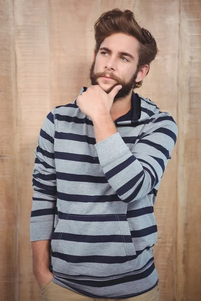 Thoughtful hipster with hand on chin — Stock Photo, Image