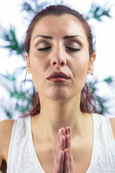 Calm woman with eyes closed and hands joined — Stock Photo, Image