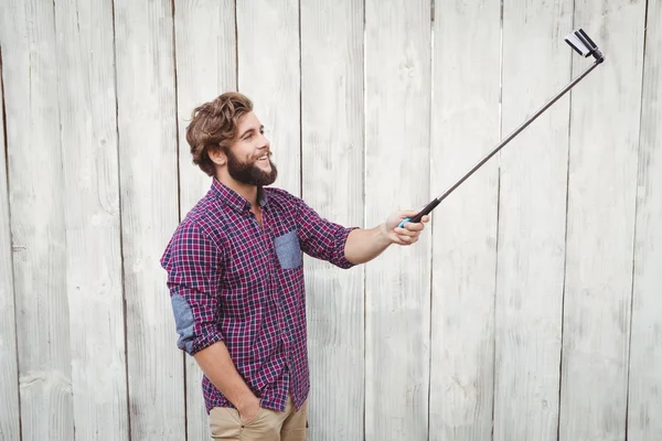 Joyeux hipster utilisant selfie stick — Photo