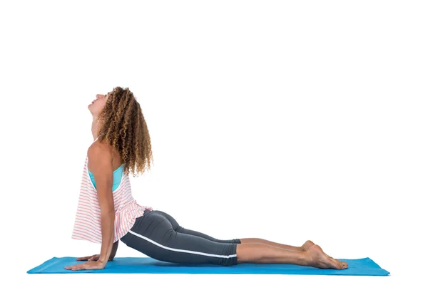 Side view of young woman exercising on mat — Stock Photo, Image