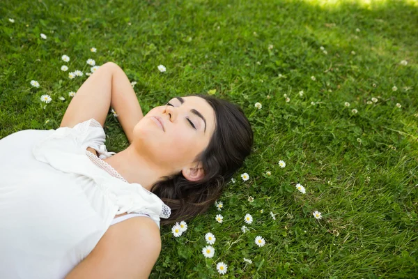 Femme relaxante avec la main derrière la tête sur les prairies — Photo