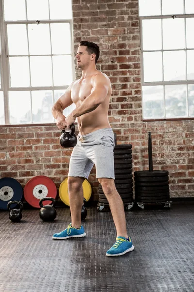 Hombre sin camisa sosteniendo kettlebell —  Fotos de Stock