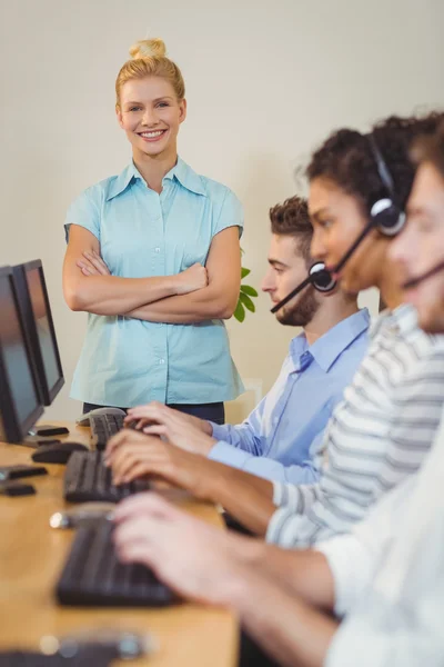 Happy businesswoman with arms crossed — Stock Photo, Image