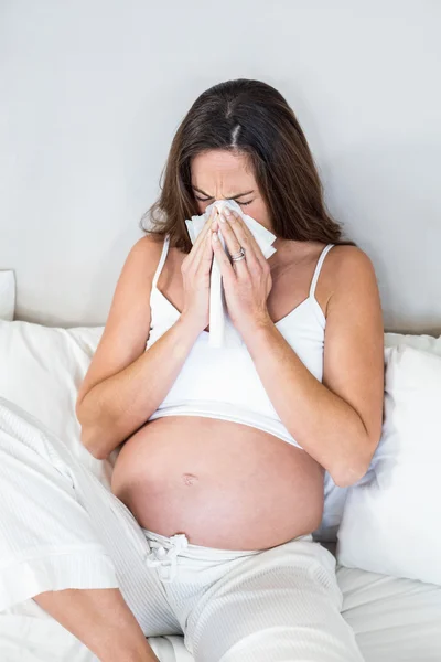 Woman blowing nose in tissue — Stock Photo, Image