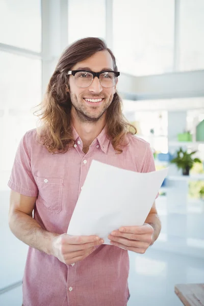 Happy hipster holding paper — Stock Photo, Image