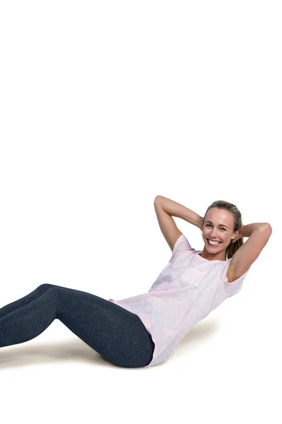Portrait of cheerful sporty woman doing sit ups — Stock Photo, Image