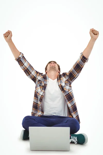 Hipster cheering while working on laptop — Stock Photo, Image
