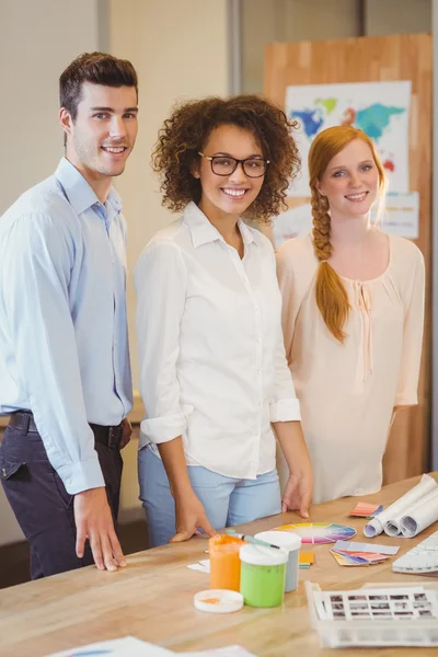 Confident business people standing by desk — Stock Photo, Image
