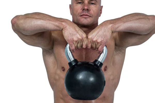Nahaufnahme einer Kettlebell, die von einem muskulösen Mann angehoben wird — Stockfoto