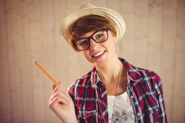 Pretty young woman holding a pen — Stock Photo, Image