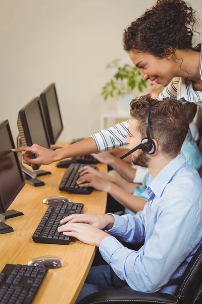 Businesswoman guiding male employee — Stock Photo, Image