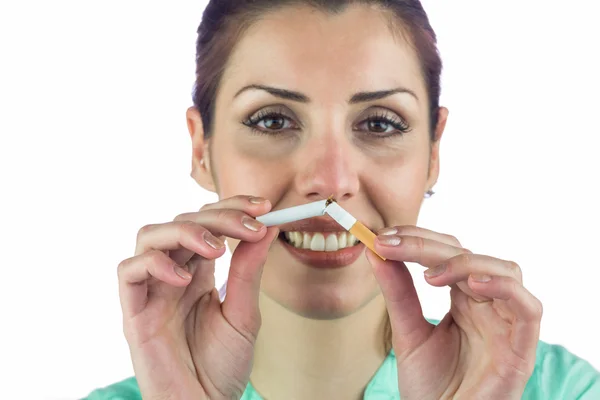 Close-up portrait of smiling woman holding cigarette — Stock Photo, Image