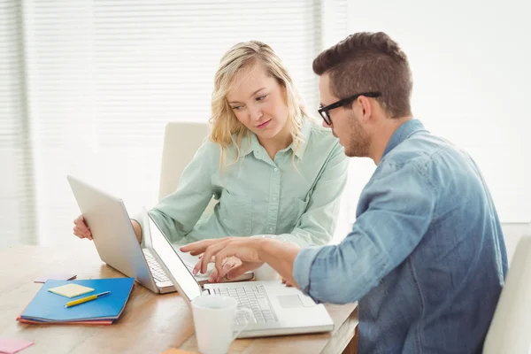 Man and woman discussing while using laptop — Stock Photo, Image