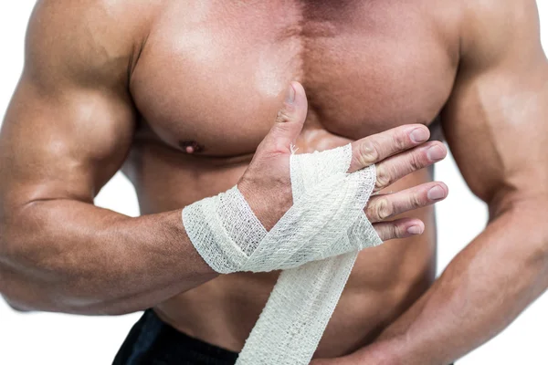 Midsection of fighter tying bandage on hand — Stock Photo, Image