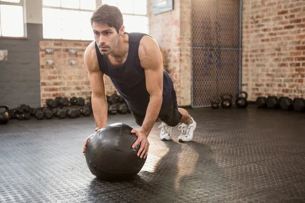 Man doing push ups on medicine ball — Stock Photo, Image