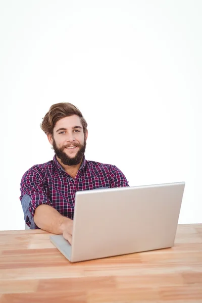 Portrait of happy hipster working on laptop — Stock Photo, Image