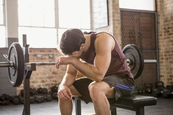 Tired man sitting on the bench — Stock Photo, Image