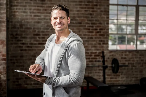 Retrato del hombre musculoso sujetando el portapapeles — Foto de Stock