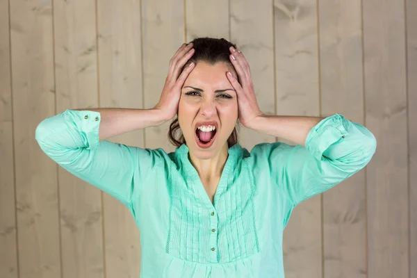 Portrait of woman with head in hands — Stock Photo, Image