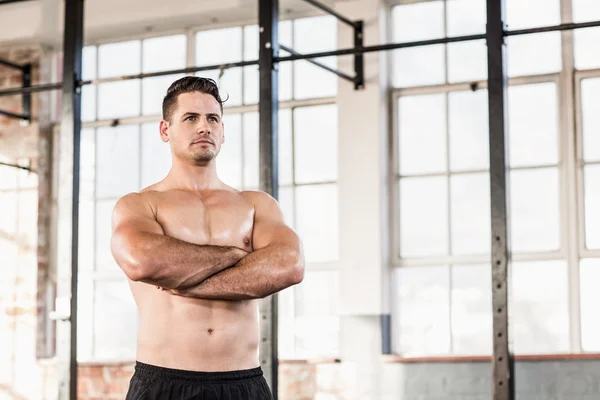 Portrait of shirtless muscular man with arms crossed — Stock Photo, Image