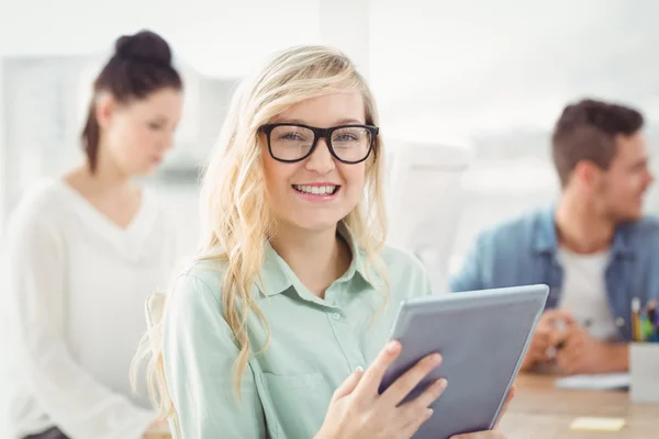 Portrait of happy woman wearing eyeglasses using digital tablet — Stock Photo, Image