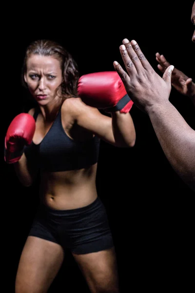 Kvinnlig fighter slår på tränare hand — Stockfoto