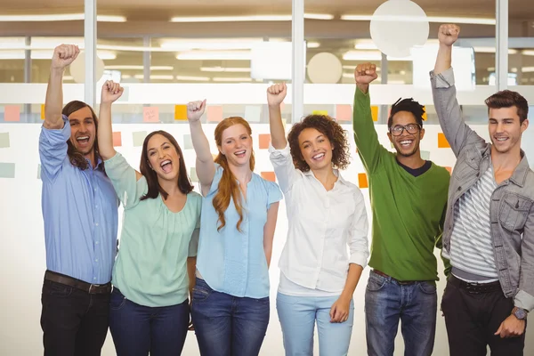 Excited business people with arm raised — Stock Photo, Image