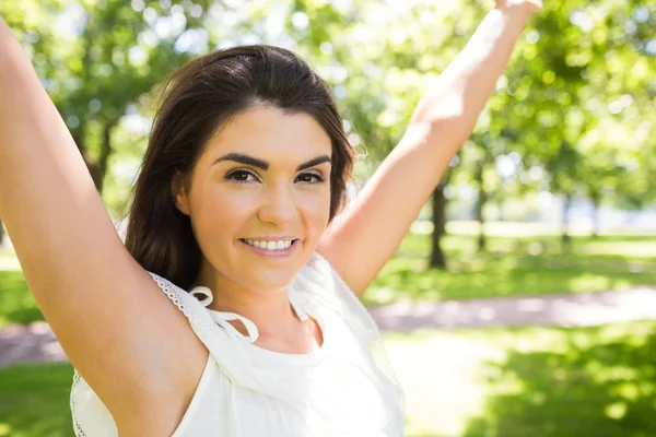 Portrait of happy woman with arms raised — Stock Photo, Image