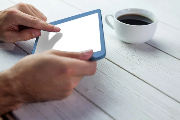 Person holding tablet on wooden desk — Stock Photo, Image