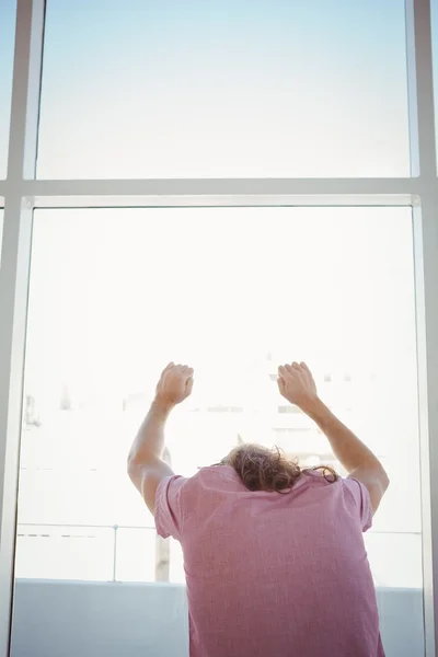 Rear view of man leaning against window glass — Stock Photo, Image