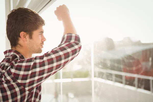 Side view of hipster looking through window — Stock Photo, Image