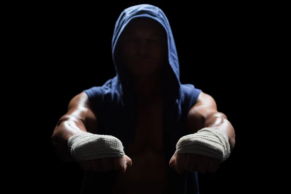 Hombre musculoso con capucha y vendaje en la mano — Foto de Stock