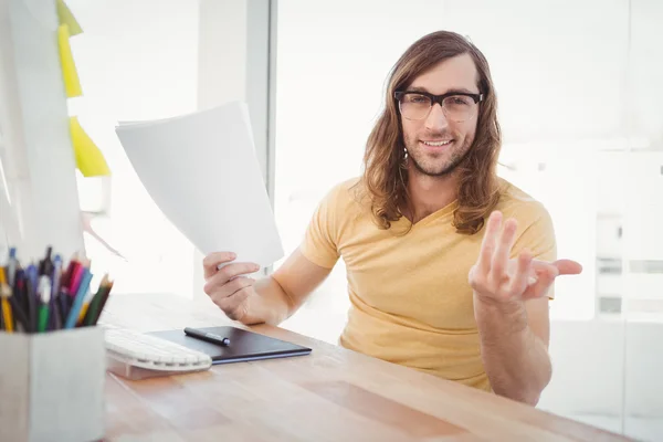 Portrait of happy hipster gesturing in office — Stock Photo, Image