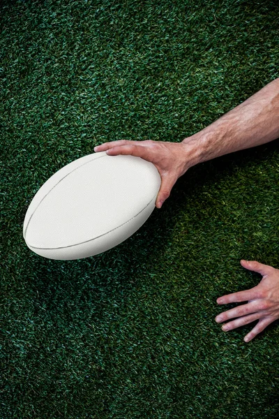 裁剪图像的一个人抱着橄榄球球 — 图库照片