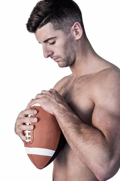 Rugby player holding the ball while looking down — Stock Photo, Image
