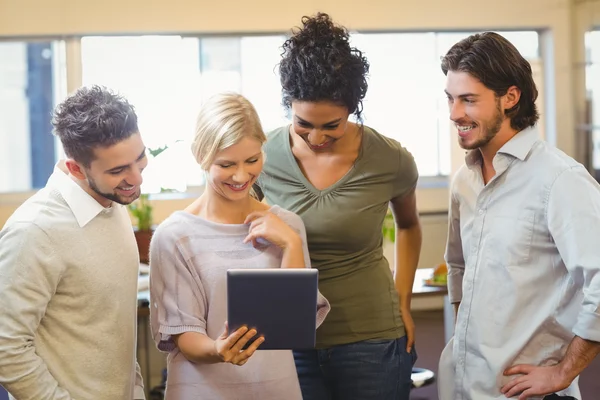 Smiling colleagues using digital tablet in office — Stock Photo, Image