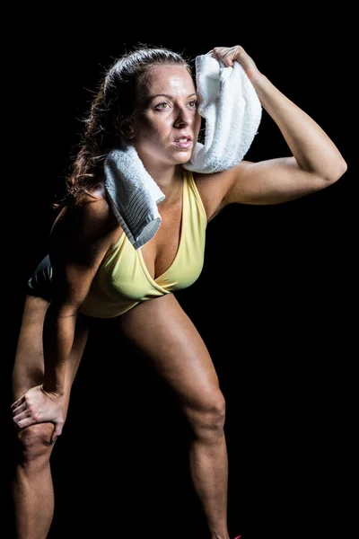 Athlete wiping sweat with towel while looking up Royalty Free Stock Photos