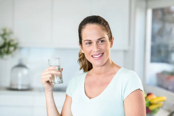 Happy woman holding water glass — Stock Photo, Image