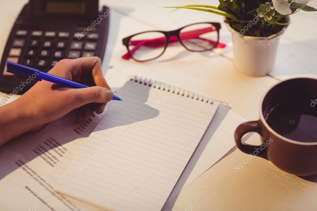 Businesswoman writing notes in book — Stock Photo © Wavebreakmedia 84918284