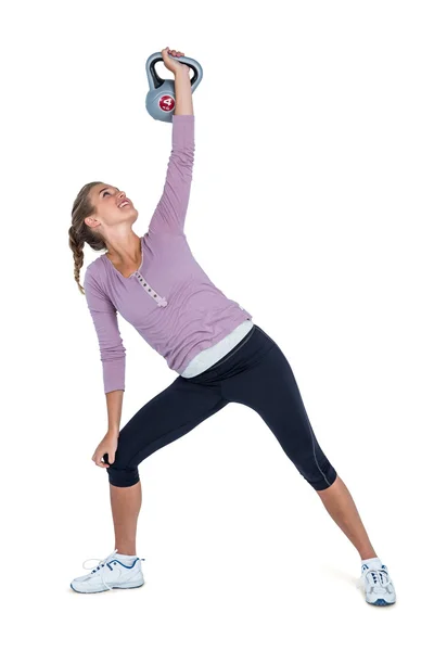 Mujer joven haciendo ejercicio con kettlebell — Foto de Stock
